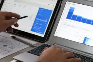 Businessman using Google Analytics in the office on his computers-min